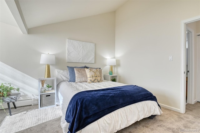 bedroom with light colored carpet and vaulted ceiling