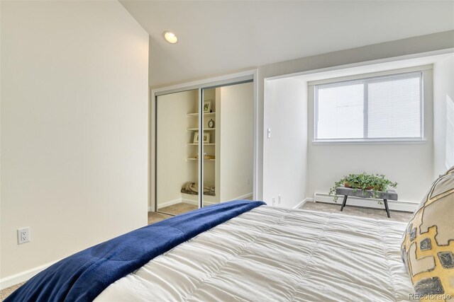 carpeted bedroom featuring a baseboard radiator and a closet