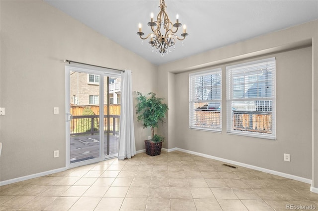 tiled spare room featuring an inviting chandelier, vaulted ceiling, and a healthy amount of sunlight