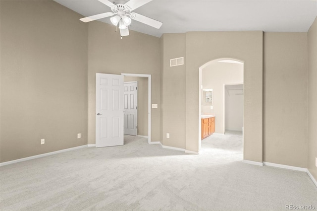 carpeted spare room with vaulted ceiling and ceiling fan