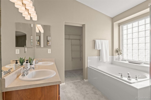 bathroom with vanity and tiled bath