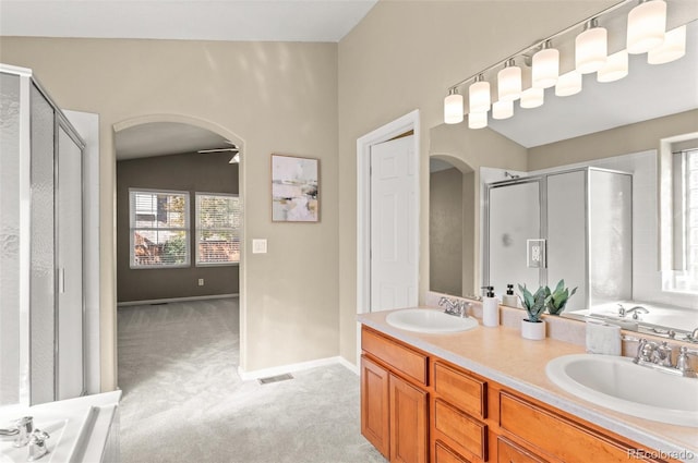 bathroom with vanity, lofted ceiling, and shower with separate bathtub