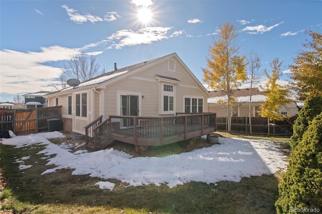 snow covered property featuring a wooden deck