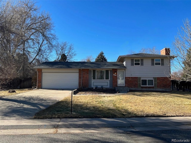 split level home with a garage and a front yard