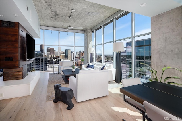 1700 Bassett St Unit 2315, Denver, CO 80202 - living area with a wall of windows, ceiling fan, and wood finished floors