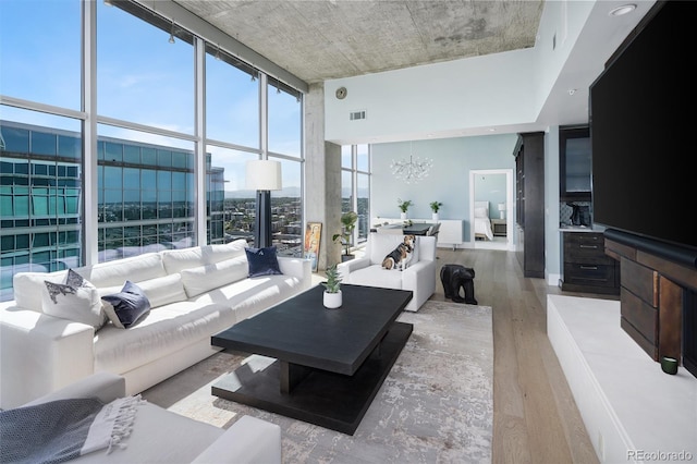 1700 Bassett St Unit 2315, Denver, CO 80202 - living area with a chandelier, wood finished floors, and a wall of windows