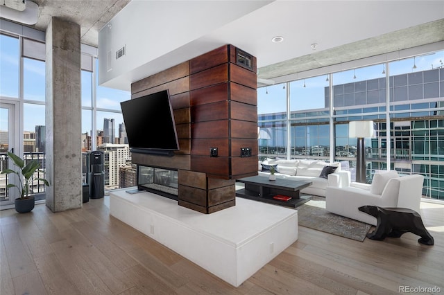 1700 Bassett St Unit 2315, Denver, CO 80202 - living area with floor to ceiling windows, hardwood / wood-style floors, plenty of natural light, and a high ceiling