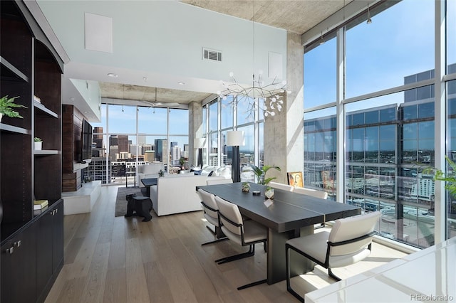 1700 Bassett St Unit 2315, Denver, CO 80202 - dining space with floor to ceiling windows, a city view, wood finished floors, and a high ceiling