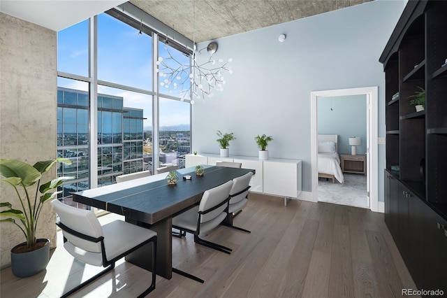 1700 Bassett St Unit 2315, Denver, CO 80202 - dining space featuring dark wood-style floors, a wall of windows, a chandelier, and a city view