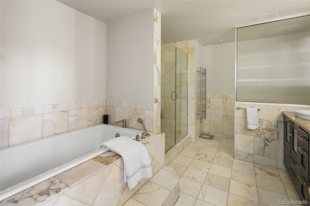 1700 Bassett St Unit 2315, Denver, CO 80202 - bathroom with vanity, a bath, a stall shower, and marble finish flooring