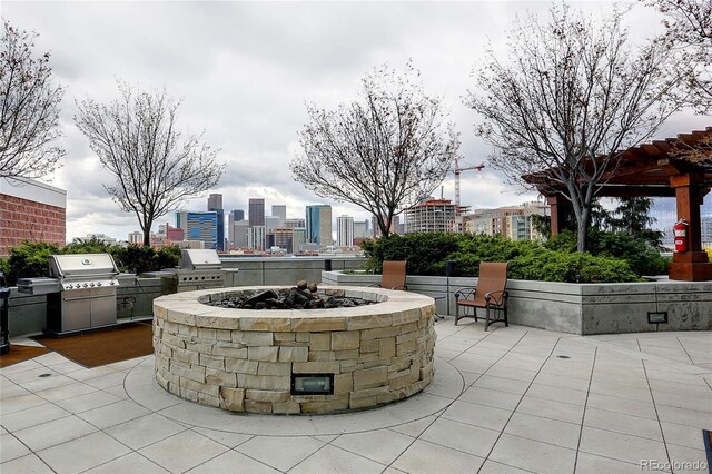 1700 Bassett St Unit 2315, Denver, CO 80202 - view of patio featuring an outdoor kitchen, an outdoor fire pit, and a view of skyline