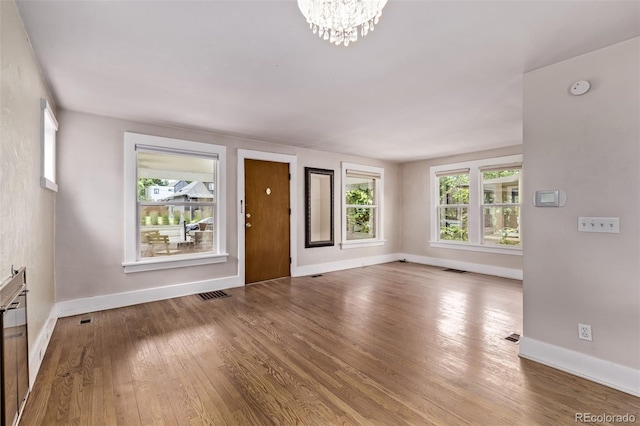 4654 Bryant St, Denver, CO 80211 - unfurnished living room with wood finished floors and a chandelier