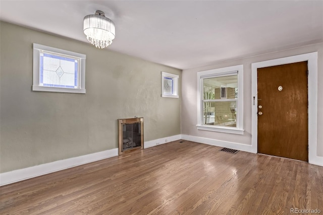 4654 Bryant St, Denver, CO 80211 - foyer featuring healthy amount of natural light, wood finished floors, a chandelier, and a fireplace