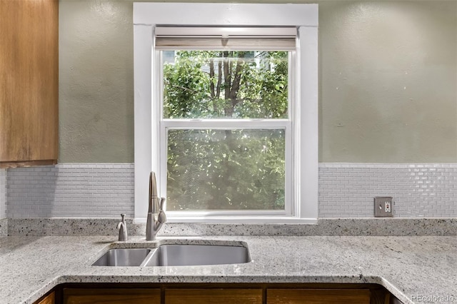 4654 Bryant St, Denver, CO 80211 - kitchen with light stone counters, tasteful backsplash, and a textured wall