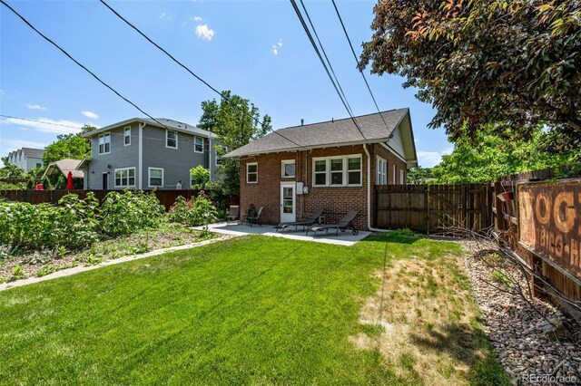 4654 Bryant St, Denver, CO 80211 - back of property with a patio, a fenced backyard, and brick siding