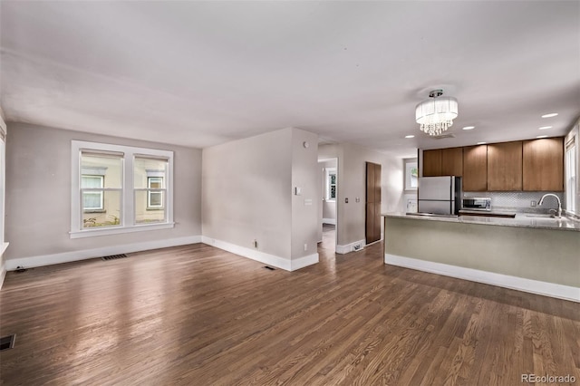 4654 Bryant St, Denver, CO 80211 - kitchen featuring freestanding refrigerator, dark wood-type flooring, a chandelier, light countertops, and recessed lighting