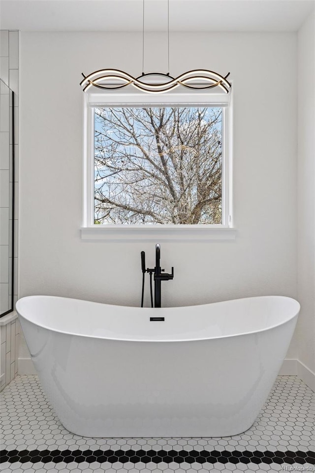 740 W County Road 10e, Berthoud, CO 80513 - bathroom featuring a freestanding tub, a wealth of natural light, and tile patterned flooring