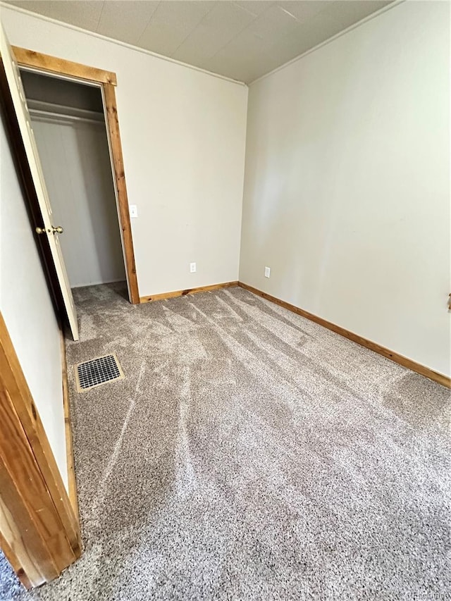 unfurnished bedroom with carpet and a closet