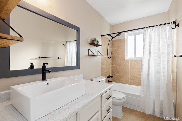 bathroom with shower / tub combo with curtain, vanity, toilet, and tile patterned floors