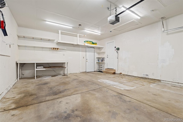 garage featuring a garage door opener and visible vents