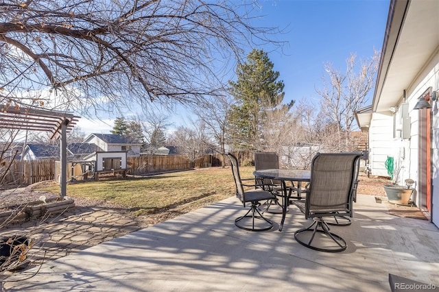 view of patio with outdoor dining area, a fenced backyard, an outdoor structure, and a pergola