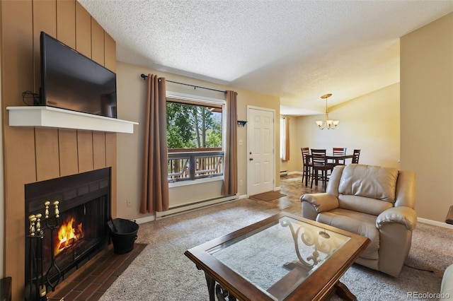 401 Forest Edge Rd Unit B2, Woodland Park, CO 80863 - living area featuring baseboard heating, a tiled fireplace, a chandelier, a textured ceiling, and carpet