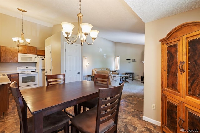 401 Forest Edge Rd Unit B2, Woodland Park, CO 80863 - dining room with a chandelier and lofted ceiling