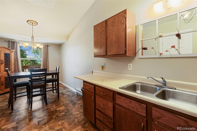 401 Forest Edge Rd Unit B2, Woodland Park, CO 80863 - kitchen featuring baseboard heating, light countertops, stone finish floors, a chandelier, and pendant lighting
