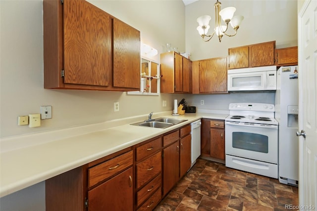 401 Forest Edge Rd Unit B2, Woodland Park, CO 80863 - kitchen with white appliances, light countertops, stone finish floors, a chandelier, and brown cabinetry