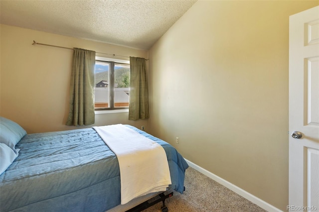 401 Forest Edge Rd Unit B2, Woodland Park, CO 80863 - carpeted bedroom with a textured ceiling and baseboards