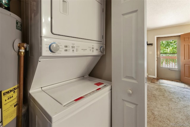 401 Forest Edge Rd Unit B2, Woodland Park, CO 80863 - washroom featuring water heater, stacked washer and clothes dryer, and carpet flooring