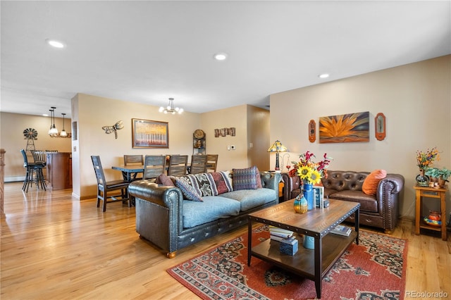 living room featuring light hardwood / wood-style flooring and a chandelier