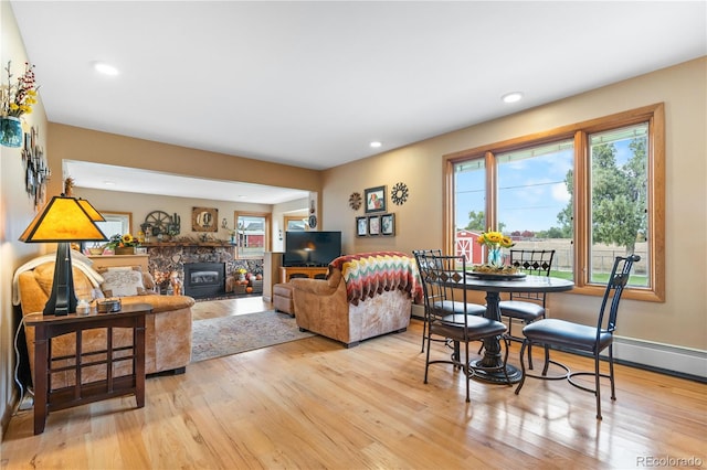 living room featuring light hardwood / wood-style floors and a wood stove