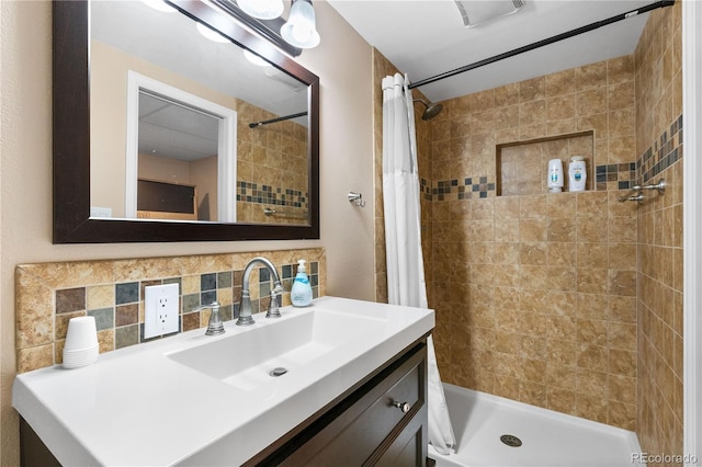 bathroom featuring vanity, decorative backsplash, and a shower with shower curtain