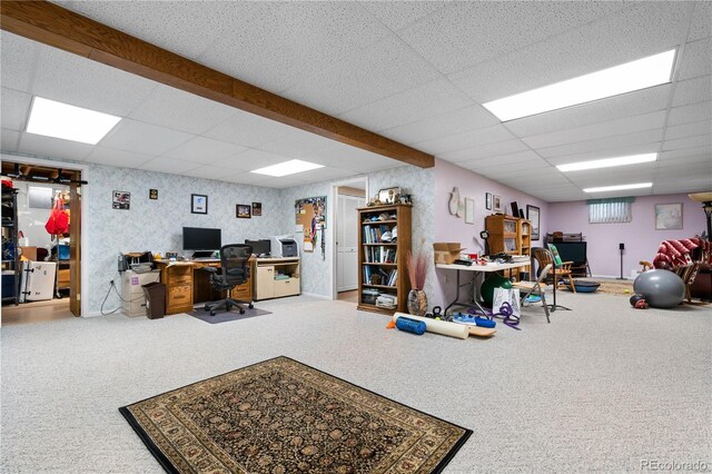 carpeted office featuring a paneled ceiling