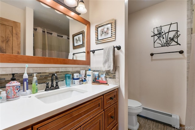 bathroom featuring backsplash, toilet, a shower with curtain, baseboard heating, and vanity