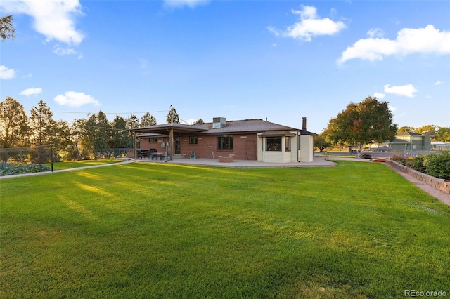 back of house featuring a yard and a patio area