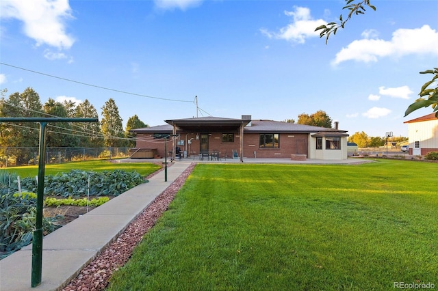 back of property featuring a lawn