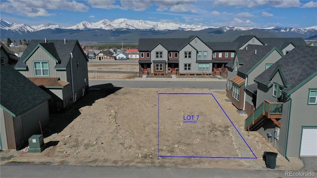 exterior space with a garage and a mountain view