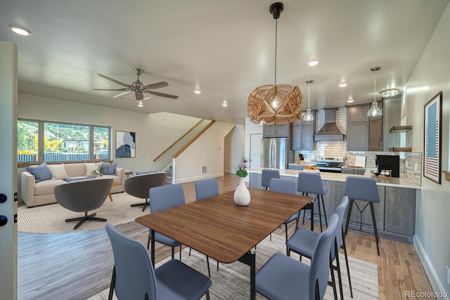 dining space featuring light wood-type flooring and ceiling fan