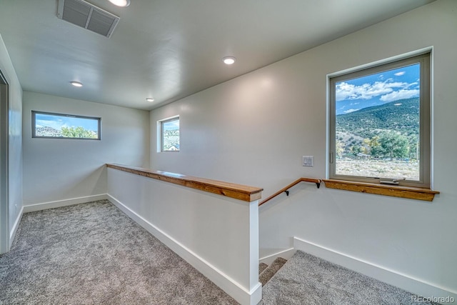 staircase with carpet flooring and plenty of natural light