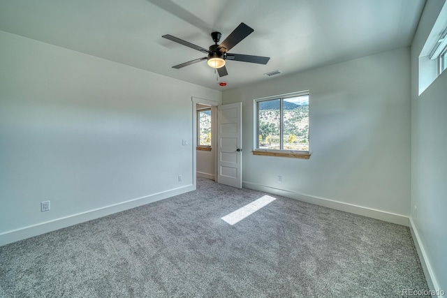 unfurnished bedroom with ceiling fan and carpet