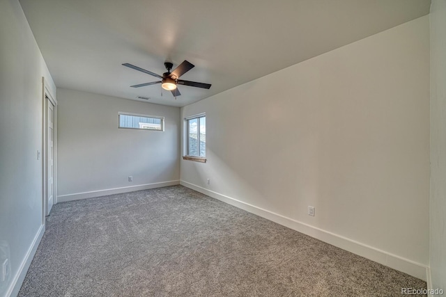 empty room featuring carpet flooring and ceiling fan