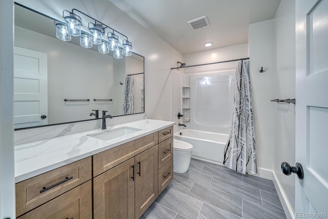 full bathroom featuring shower / bath combo, vanity, and toilet