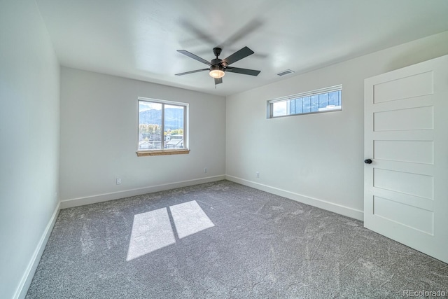 unfurnished room featuring ceiling fan and carpet floors