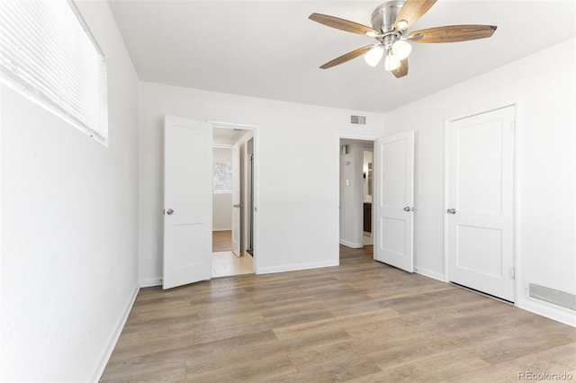 unfurnished bedroom featuring light wood-type flooring, visible vents, and baseboards