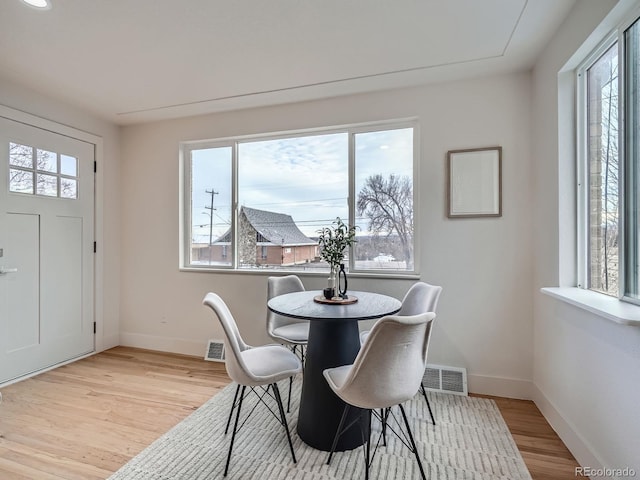 dining space with light hardwood / wood-style flooring