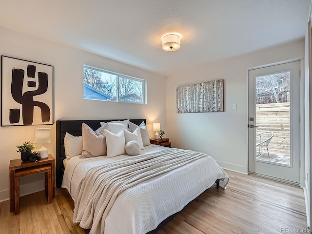 bedroom featuring access to outside and light hardwood / wood-style flooring