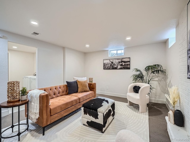 carpeted living room with washer and dryer