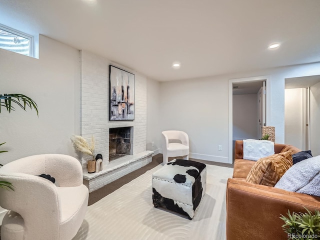 living room featuring wood-type flooring and a fireplace